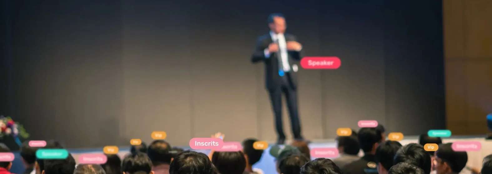 A speaker on stage in front of the audience